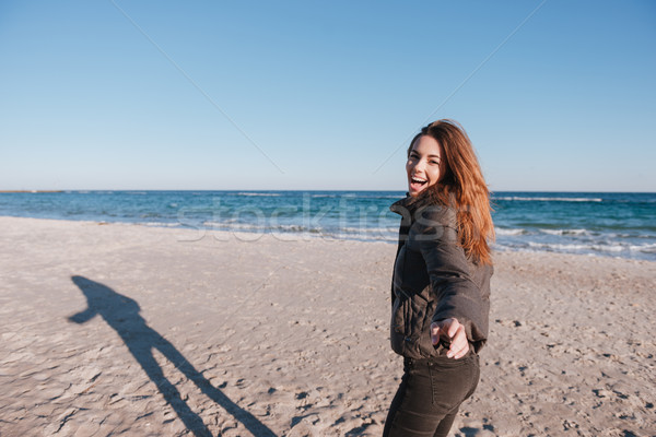 Woman in warm jacket on date near the sea Stock photo © deandrobot