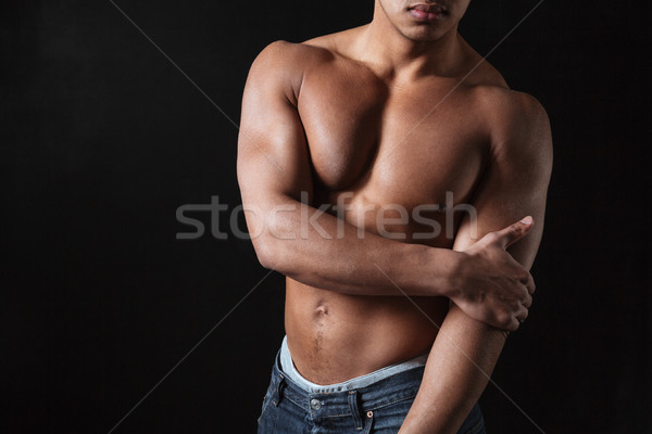 African sportsman posing over black background. Stock photo © deandrobot