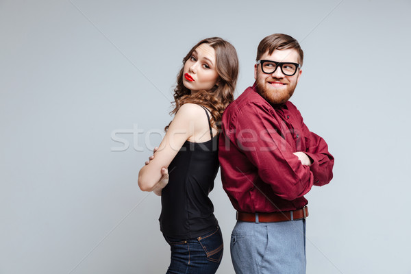 Pretty woman and Male nerd standing backs to each other Stock photo © deandrobot