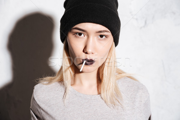 Close up portrait of Serious Hipster woman in black hat Stock photo © deandrobot