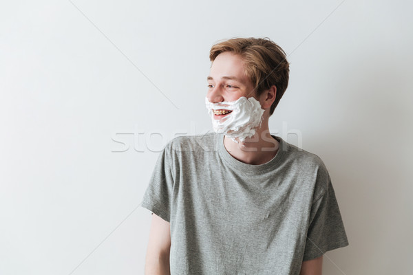 Boldog férfi hab másfelé néz póló szürke Stock fotó © deandrobot