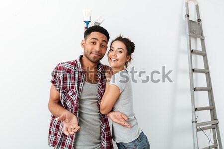 Young couple making repairs in the apartment Stock photo © deandrobot