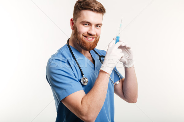 Portrait of a happy attractive medical doctor or nurse Stock photo © deandrobot