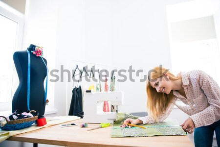 Young serious woman fashion illustrator drawing Stock photo © deandrobot
