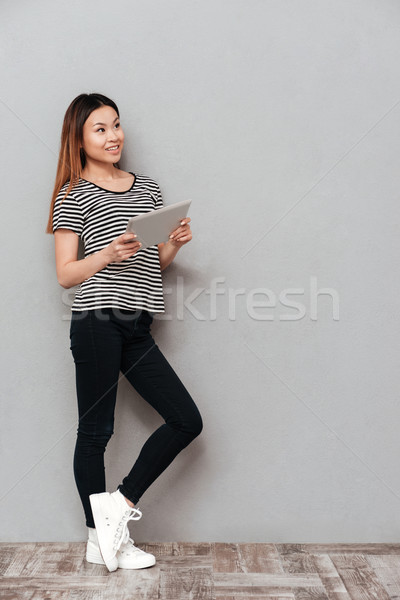 Beautiful young woman using tablet computer. Stock photo © deandrobot