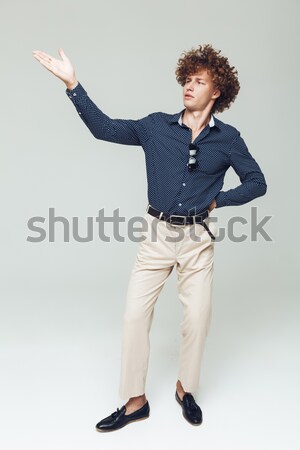 Retro man dressed in shirt sitting and posing Stock photo © deandrobot