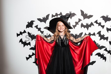 Emotional happy young woman in witch halloween costume Stock photo © deandrobot