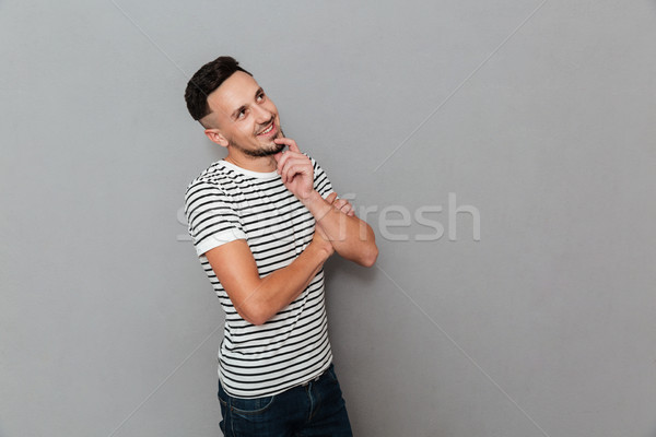 Portrait of a smiling attractive man thinking Stock photo © deandrobot