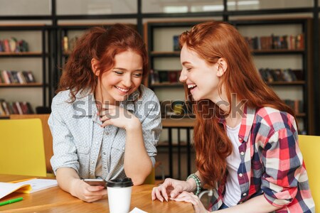 Portrait of a two smiling teenage girls listening to music Stock photo © deandrobot