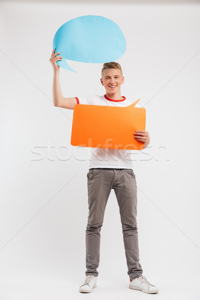 Full length photo of pleased advertiser boy wearing casual t-shi Stock photo © deandrobot