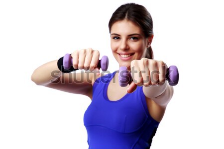 Young happy sport woman with dumbbells working out isolated on white background. Focus on dumbbells Stock photo © deandrobot