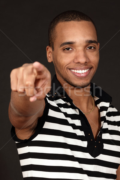 Fiatal boldog lezser jóképű férfi pontok sötét Stock fotó © deandrobot
