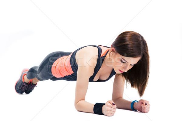 Young sporty woman doing exercises on the floor Stock photo © deandrobot
