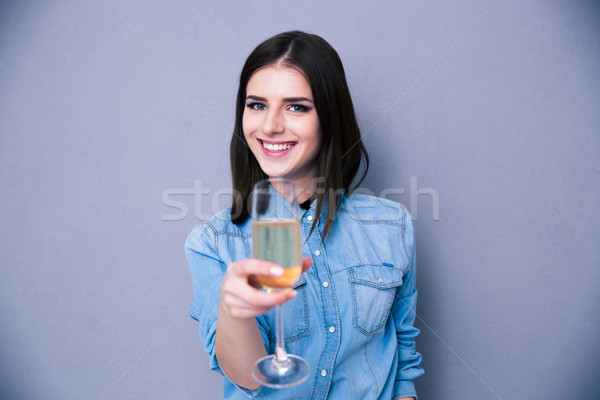 Charming young woman standing with glass of champagne Stock photo © deandrobot