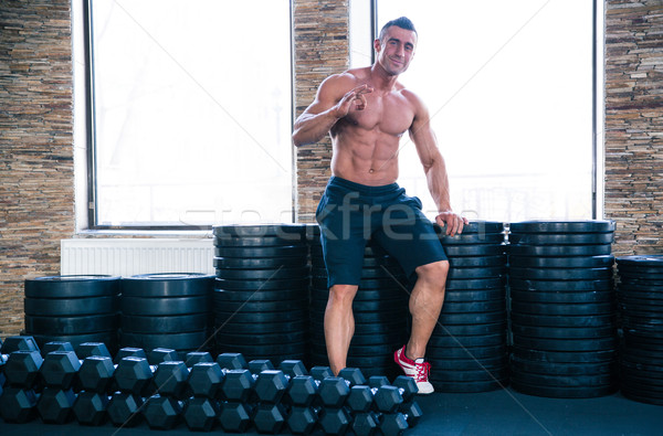 Muscular happy man showing ok sign  Stock photo © deandrobot
