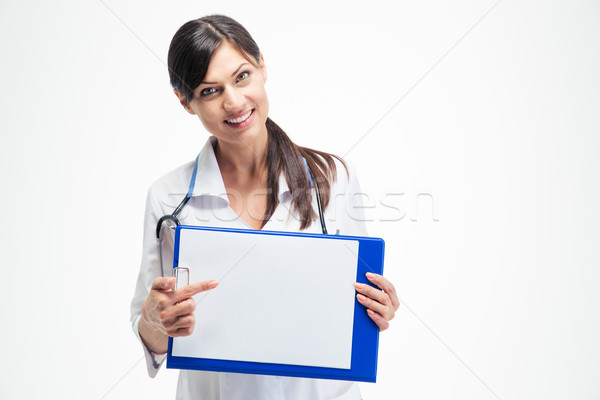Female doctor pointing finger on clipboard Stock photo © deandrobot