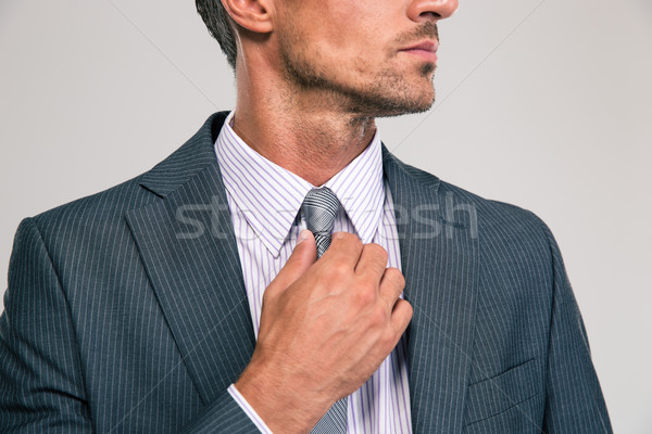 Businessman straightening his tie Stock photo © deandrobot