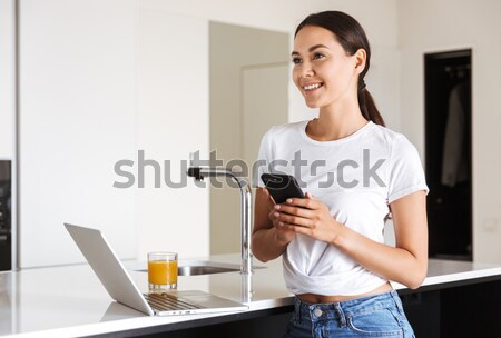 Cheerful woman painter using cell phone in art studio Stock photo © deandrobot