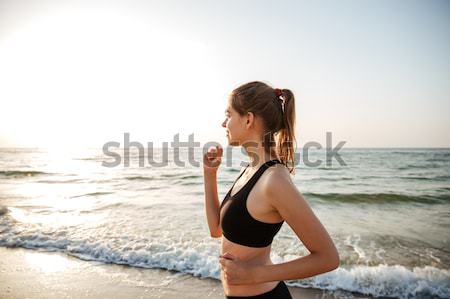 Beautiful young woman stretching during yoga on the beach stock ...