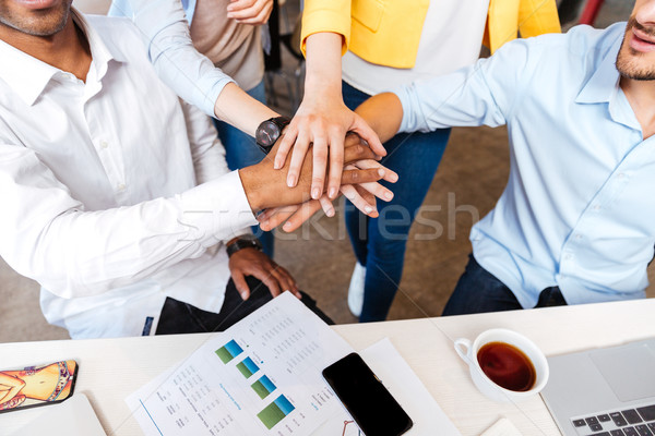 Group of business people joining hands Stock photo © deandrobot