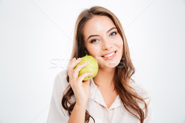 Stock photo: Close up portrait of a smiling girl holding green apple