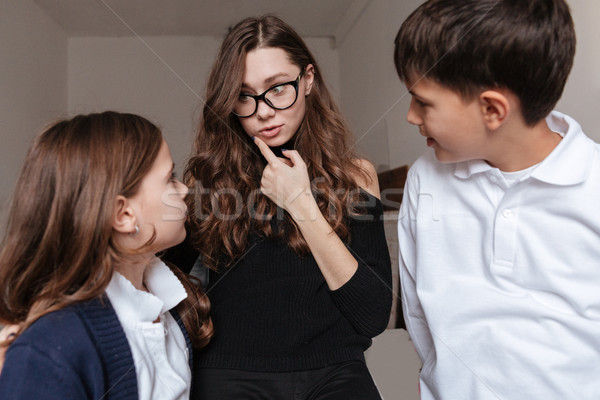 Beautiful young mother talking with her son and daughter Stock photo © deandrobot