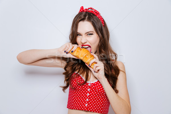 Modell croissant alsónemű lány eszik néz Stock fotó © deandrobot