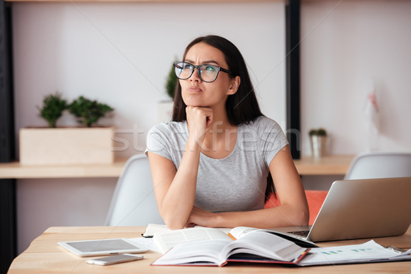 Concentrated woman indoors working with documents. Stock photo © deandrobot