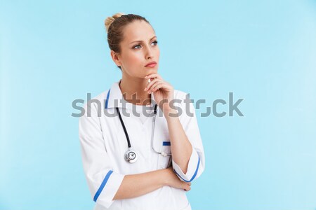 Portrait of a young nurse with stethoscope thiking about something Stock photo © deandrobot