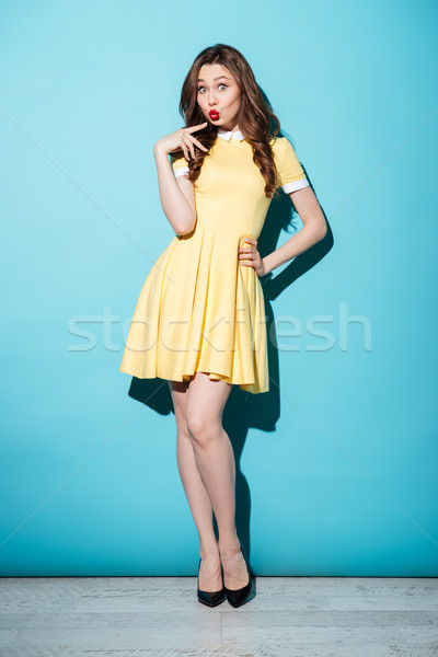 Pretty young brunette woman in yellow dress Stock photo © deandrobot