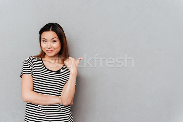 Young woman showing at blank space Stock photo © deandrobot