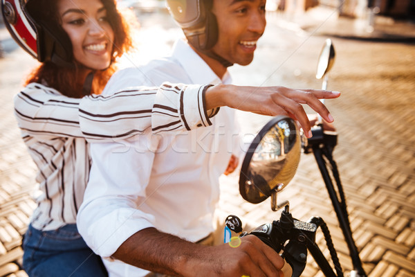 Cropped Side view of pleased african couple rides on motorbike Stock photo © deandrobot