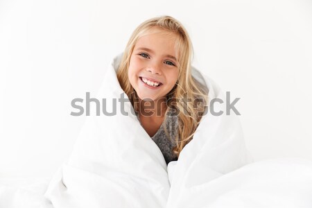 Close-up portrait of smiling kid covering with white blanket, lo Stock photo © deandrobot
