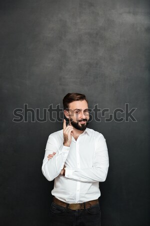 Brunette businessman posing on camera with tricky happy look, po Stock photo © deandrobot