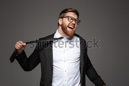 Portrait of a mad young businessman Stock photo © deandrobot