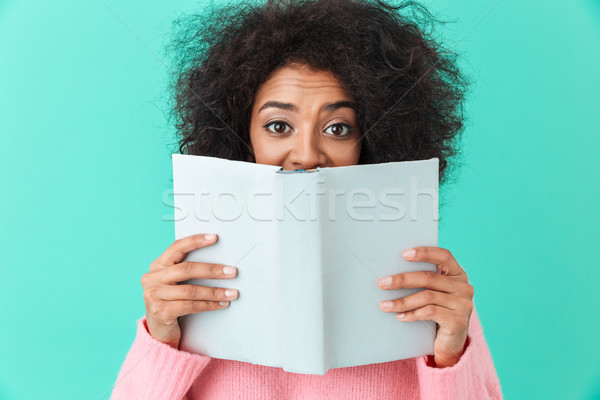 Positive image of american woman 20s with afro hairstyle looking Stock photo © deandrobot