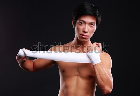 Boxer preparing for a fight bandaging his hands  Stock photo © deandrobot