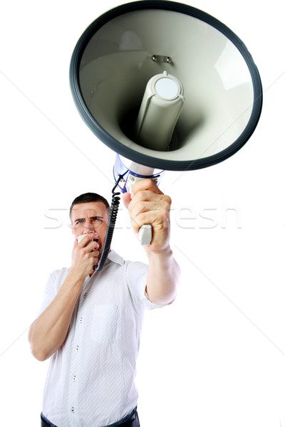 Portrait of a man roaring loudly into megaphone over white background Stock photo © deandrobot