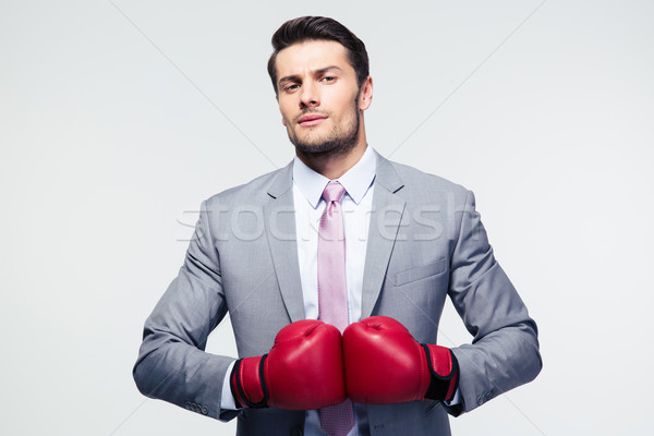 Businessman standing with boxing gloves  Stock photo © deandrobot