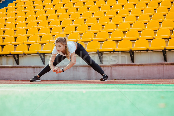 Fitness woman doing stretching exercises Stock photo © deandrobot