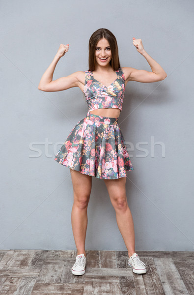 Szórakoztató vicces lány mutat bicepsz csinos Stock fotó © deandrobot