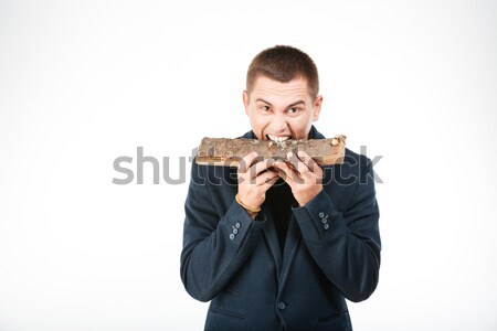 Businessman biting wooden timber Stock photo © deandrobot
