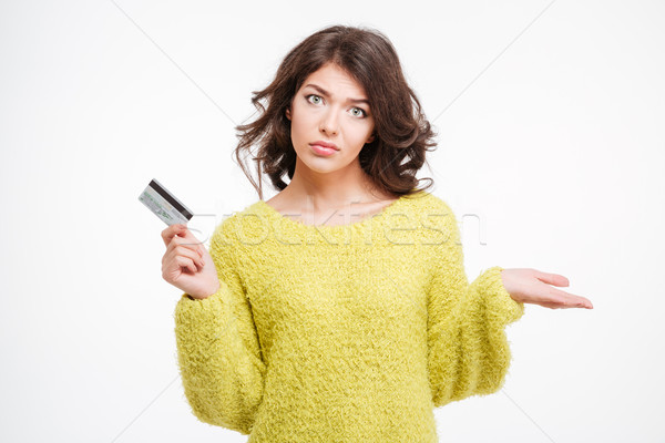 Sad woman holding bank card and copyspace on the palm  Stock photo © deandrobot