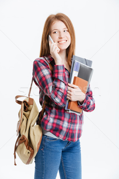 Happy female student talking on the phone Stock photo © deandrobot