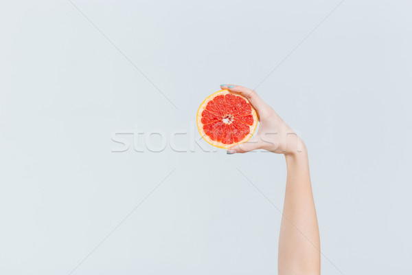 Femeie mână grapefruit izolat alb Imagine de stoc © deandrobot