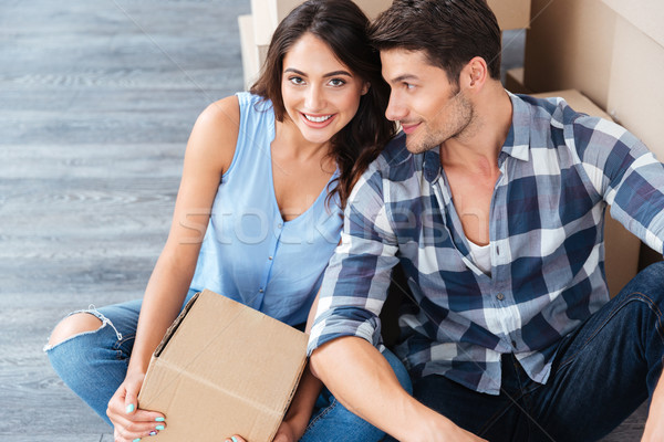 Young married couple sitting in their new house Stock photo © deandrobot