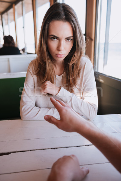 Vertical image of young touchy woman in cafe Stock photo © deandrobot
