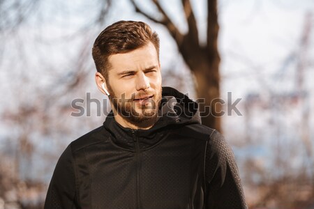 Relaxed bearded man standing in the forest with eyes closed. Stock photo © deandrobot