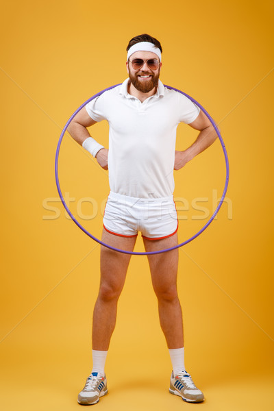 Smiling young sportsman wearing glasses with gymnastic hoop Stock photo © deandrobot