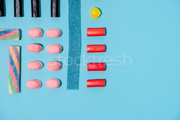 Top view of a colorful sugar candies in a row Stock photo © deandrobot